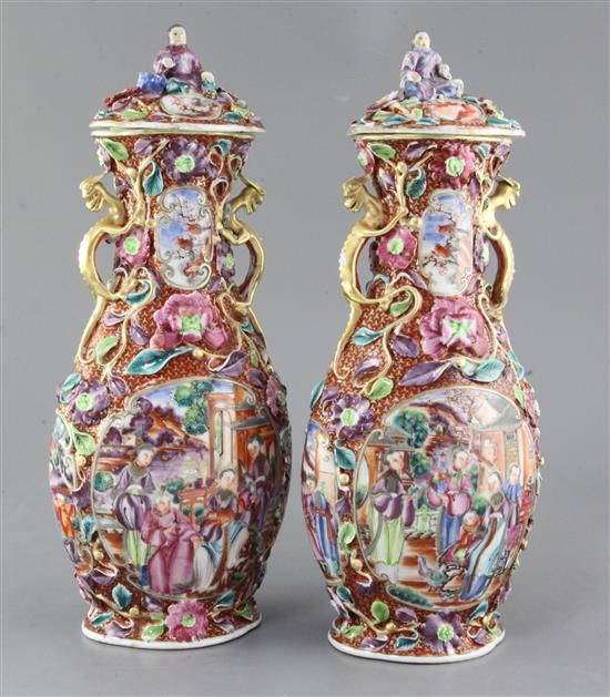 A pair of Chinese famille rose Mandarin vases and covers, Qianlong period, 35.5cm, some restorations